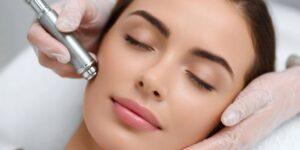 Mulher com olhos fechados recebendo tratamento estético facial com aparelho de tecnologia avançada, aplicado por profissional com luvas, focado em firmeza e rejuvenescimento da pele do rosto.